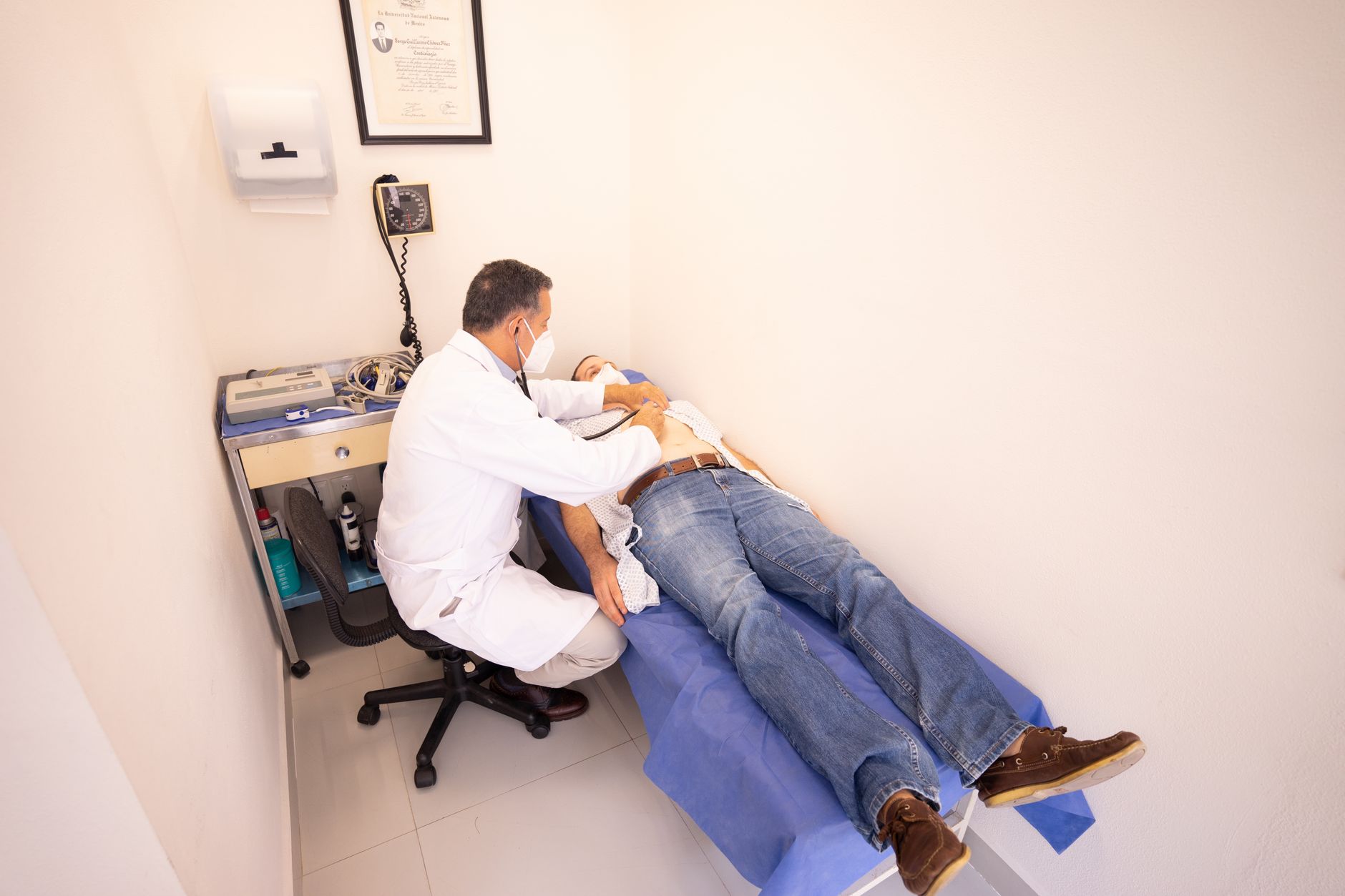 Doctor examining a patient with a stethoscope in a clinic