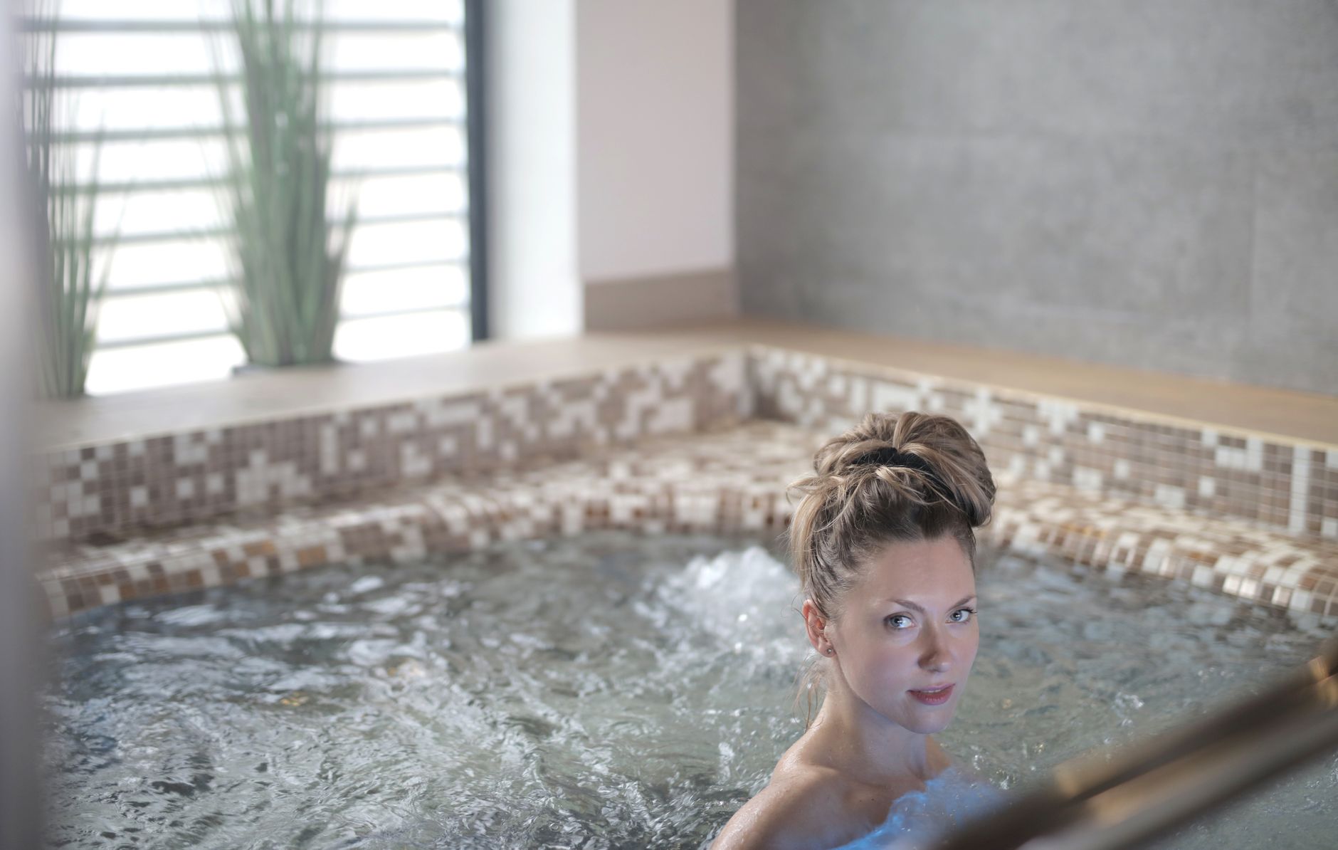 Woman relaxing in an indoor spa jacuzzi